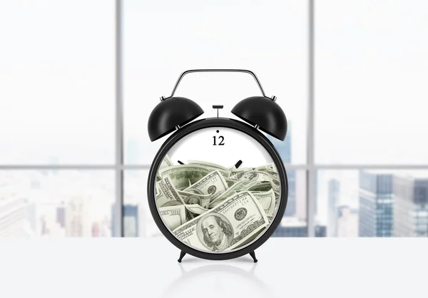 An alarm clock with dollar bills inside is on the table. The concept of \'time is money\' and a time management. Panoramic New York office background.