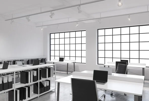 Workplaces in a bright modern loft open space office. Tables equipped with laptops; corporate documents\' shelves. White copy space in the panoramic windows. 3D rendering.