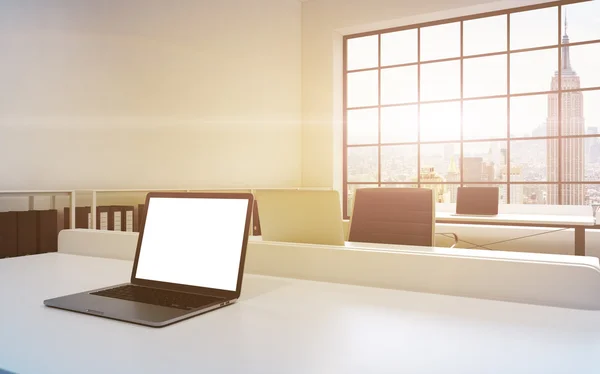 Workplaces in a bright modern loft open space office. Tables equipped with laptops, white copy space in the screen. Docs shelves. White copy space in the panoramic windows. 3D rendering. Toned image.