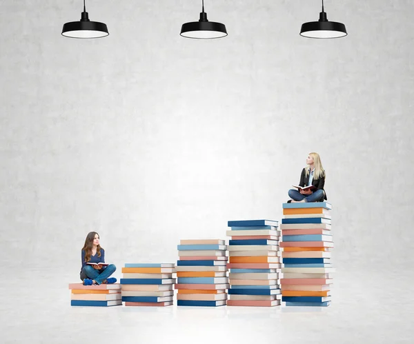 Two young women sitting books thinking about future, dreaming