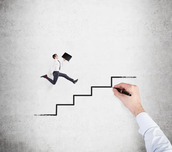 Young businessman with a folder running up a drawn stairs along a concrete wall, hand drawing steps.