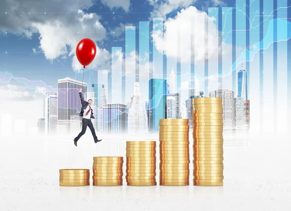 Businessman flying on a red baloon over a bar chart made of coins.