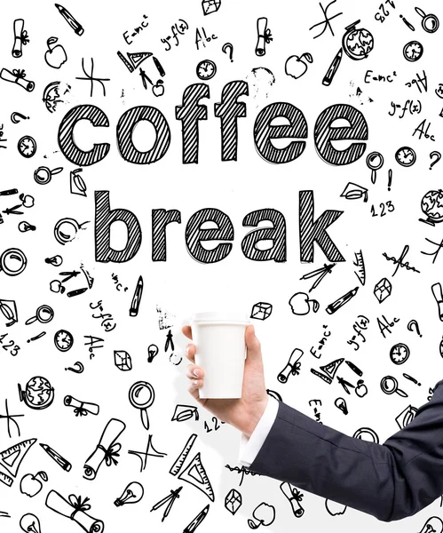 A hand in a black suit holding a paper cup. \'Coffee break\' written over it. White background with different scientific symbols. Concept of coffee break.