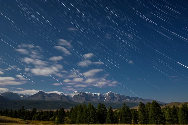 Mountains star tracks clouds forest