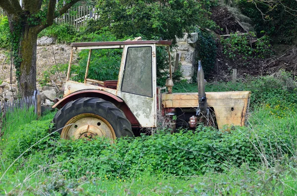 Old tractor in the abandoned garden