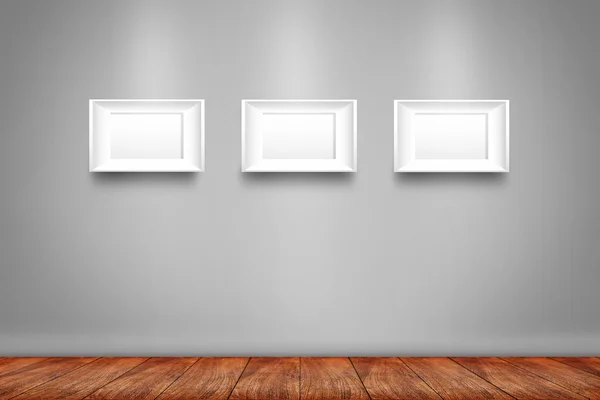 Collage of three white photo frames on the wall