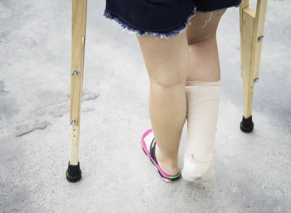 Close up of hands holding crutches on the street