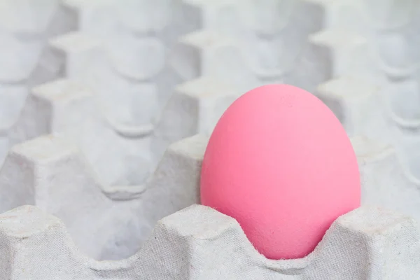 Pink preserved egg in paper package