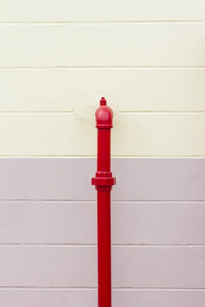 Red industrial pipe on the wall