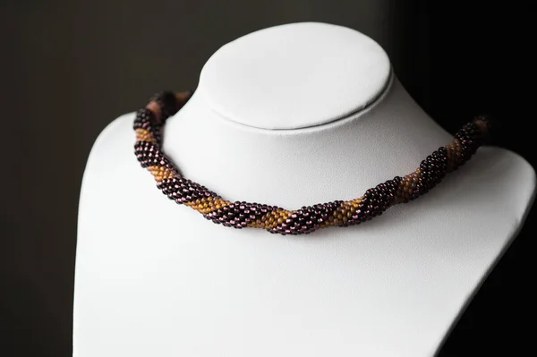 Handmade crocheted necklace made of beads of two colors