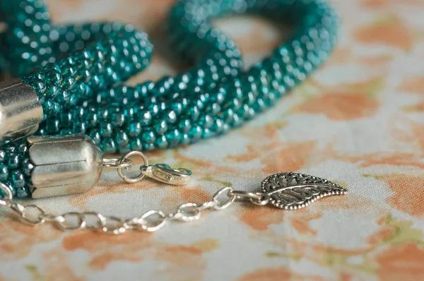 Fragments of a knitted necklace from beads of color aquamarine