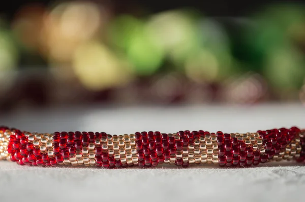 Crocheted beaded necklace of red and golden color