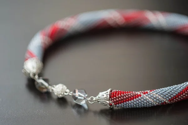Crochet Necklace from beads of gray, red and white color