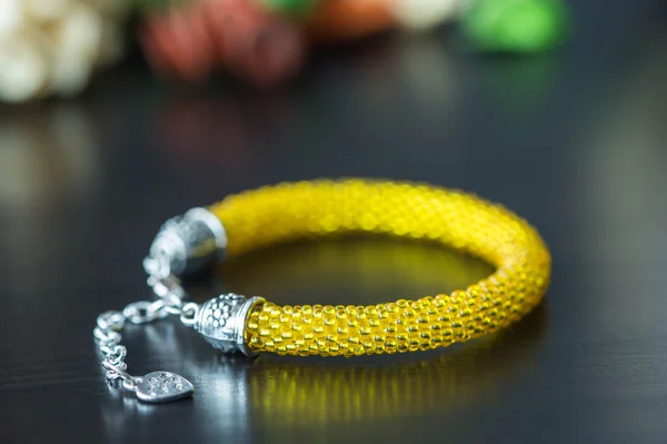 Crochet beaded bracelet from beads of yellow color
