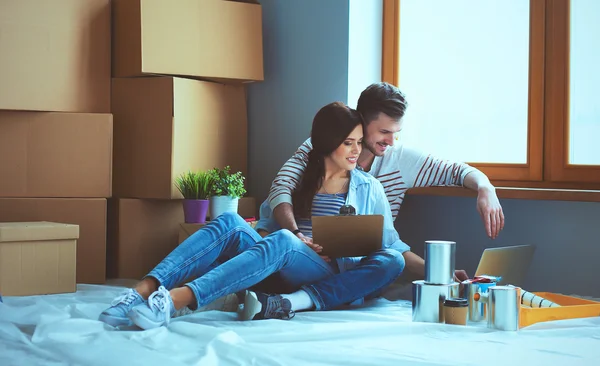 Young couple  sitting on the floor of their new apartment