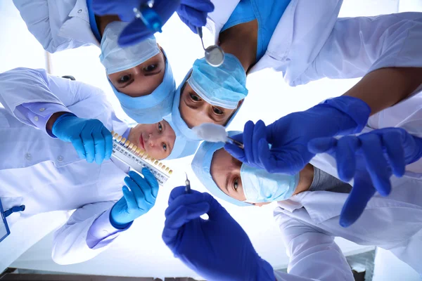 Surgeons team, woman wearing protective uniforms,caps and masks