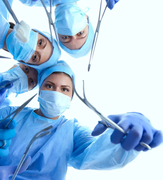 Surgeons team,  woman wearing protective uniforms,caps and masks