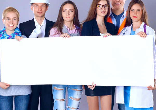 Portrait of smiling people with various occupations holding blank billboard