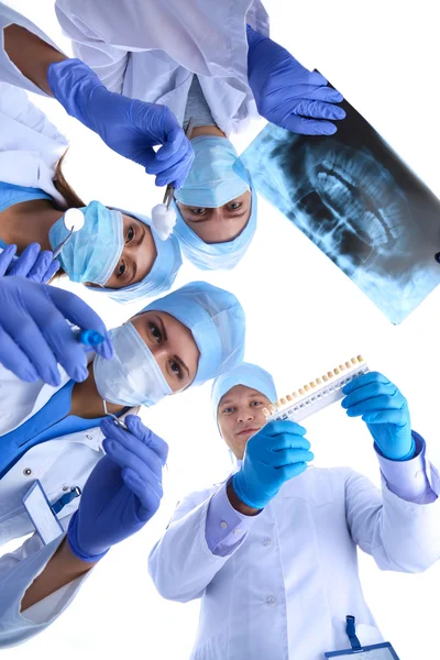 Surgeons team,  woman wearing protective uniforms,caps and masks