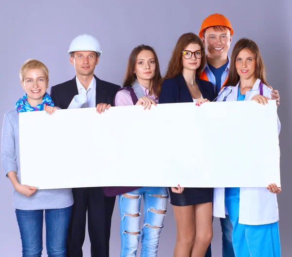 Portrait of smiling people with various occupations holding blank billboard