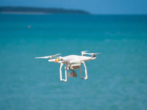 Phantom quadrocopter drone in flight against a blue sky