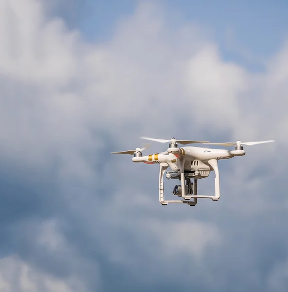 Phantom quadrocopter drone in flight against a blue sky
