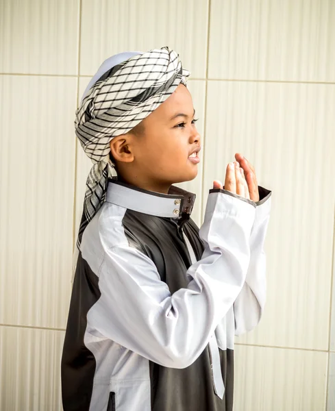 Unidentified muslim child prays for Allah