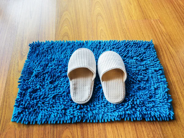 White clothing fluffy slippers on carpet