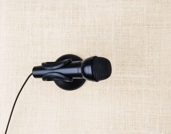 Black microphone on cloths background
