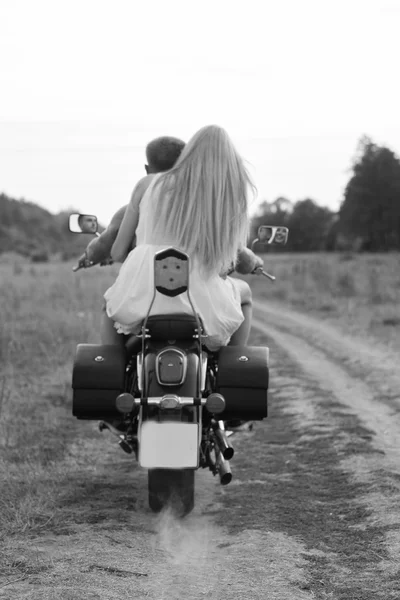 Happy couple traveling on a motorcycle.