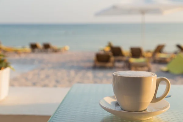 A cup of tasty coffee in a cafe on the beach. A delicious drink. Relax with a sea view. Photos for magazines, backgrounds, posters and websites.