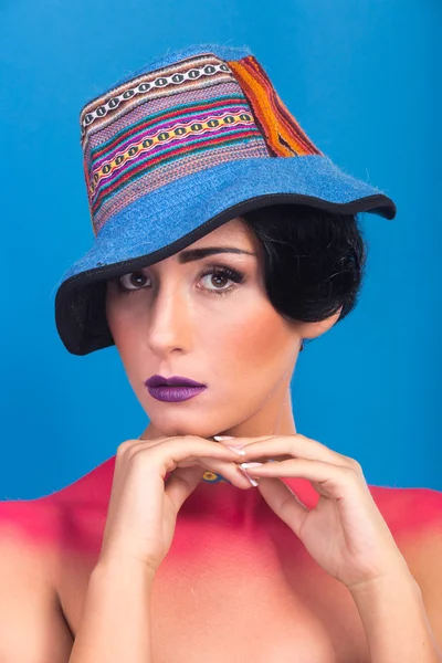Beautiful, bright stage make-up. Originality, creative image of the girl in a hat.