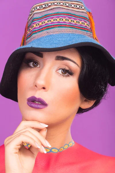Beautiful, bright stage make-up. Originality, creative image of the girl in a hat.