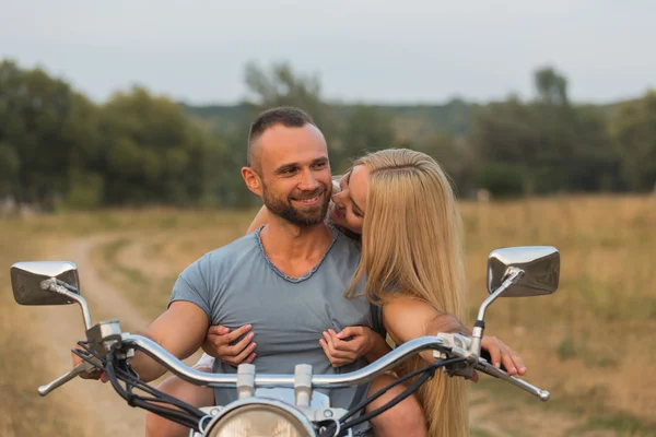 Beautiful couple in love at mototsikle.