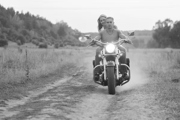 Happy couple traveling on a motorcycle. Extraordinary lifestyle.