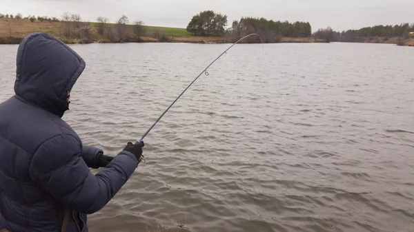 Fisherman on the river bank