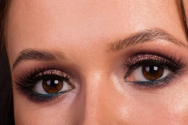 Great professional make-up eyes. Glitter, eye shadow, highlighter, eyeliner. Eye of girl close-up.