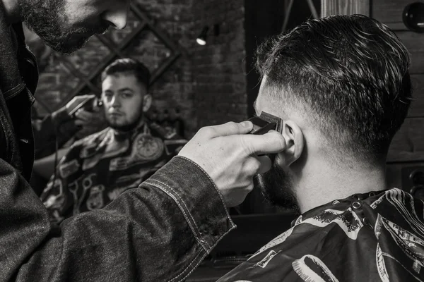 Haircut men Barbershop. Men\'s Hairdressers; barbers. Barber cuts the client machine for haircuts.