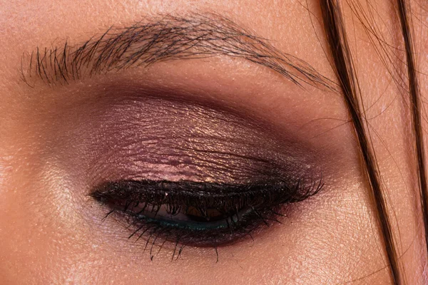 Great professional make-up eyes. Glitter, eye shadow, highlighter, eyeliner. Eye of girl close-up.