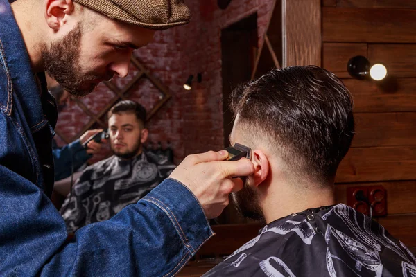 Haircut men Barbershop. Men\'s Hairdressers; barbers. Barber cuts the client machine for haircuts.