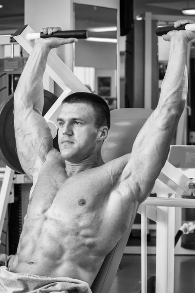 Athlete in the gym making vertical thrust. The power to exercise the muscles of the back. Photos for sporting magazines, posters and websites.