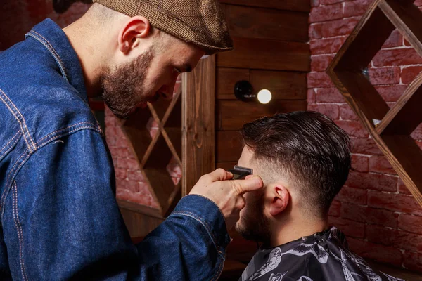 Haircut men Barbershop. Men\'s Hairdressers; barbers. Barber cuts the client machine for haircuts.