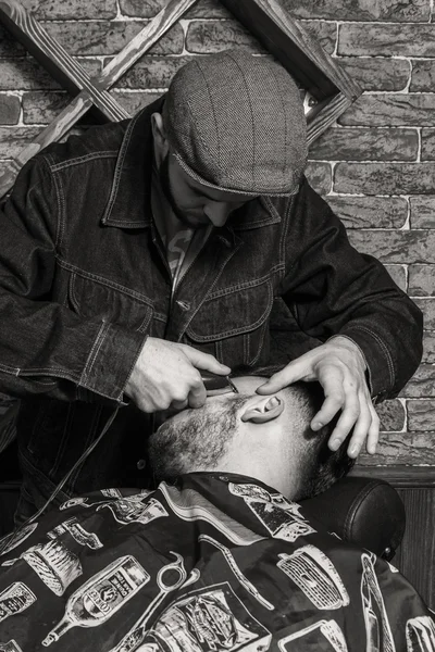 Haircut men Barbershop. Men's Hairdressers; barbers. Barber cuts client with scissors.