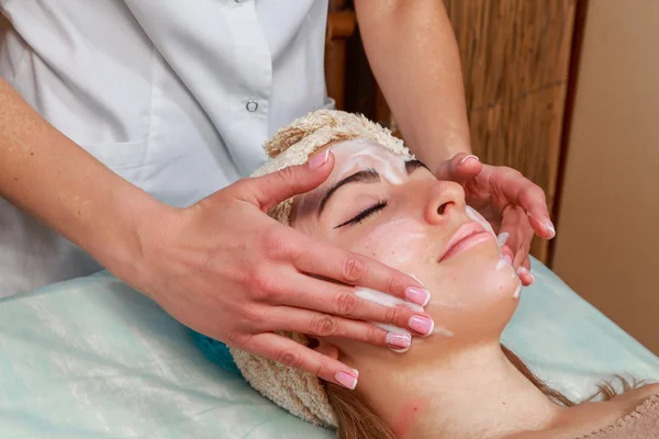 Beauty treatments for problem skin. The girl in the spa salon, applying cream.