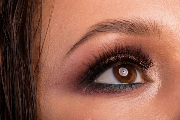 Beautiful female eye close-up. professional makeup.