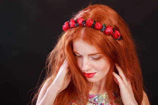 Beautiful red-haired girl with a wreath in her hair. Accessories for hair - wreaths. Hair ornaments. Gorgeous red-haired girl.
