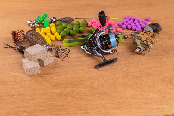 Fishing lure on a wooden table. Fishing tackle, baits, floats, feeders.