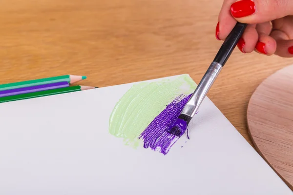 Tools of the artist. Drawing, preparation for painting. Drawing tools on a wooden background.