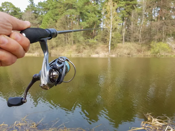 Angler with spinning. Successful fishing.