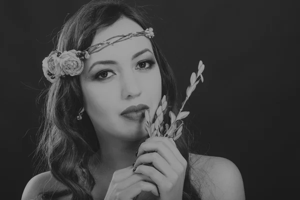 Black and white portrait of a beautiful girl in a wreath